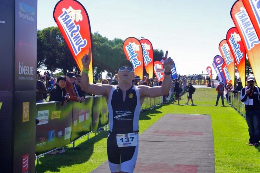Busselton ironman competitor crosses the finish line