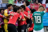 Germany looks on as South Korea celebrates at World Cup