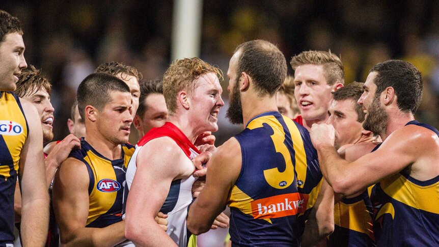 Melbourne's Clayton Oliver and West Coast's Will Schofield confront each other at Subiaco Oval.