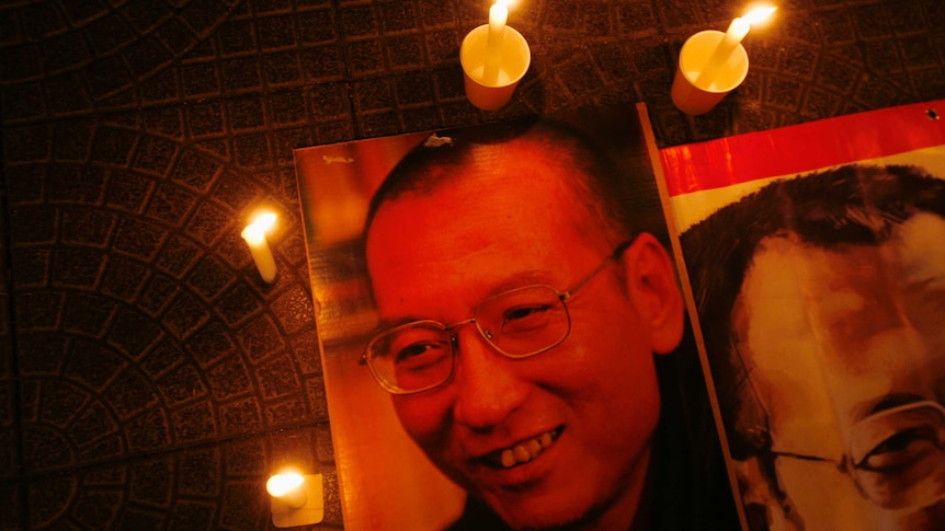 Candles are placed around portraits of jailed Chinese pro-democracy activist Liu Xiaobo during a candlelight vigil.