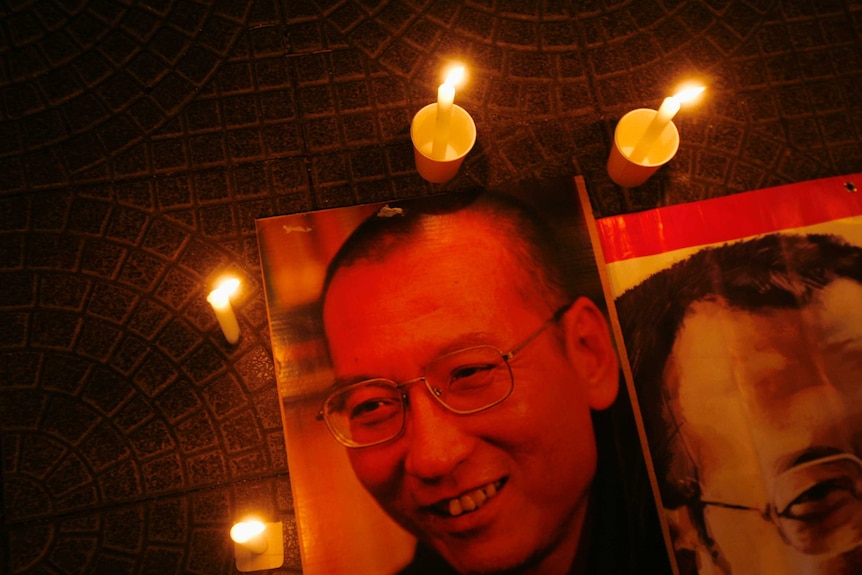 Candles are placed around portraits of jailed Chinese pro-democracy activist Liu Xiaobo during a candlelight vigil.
