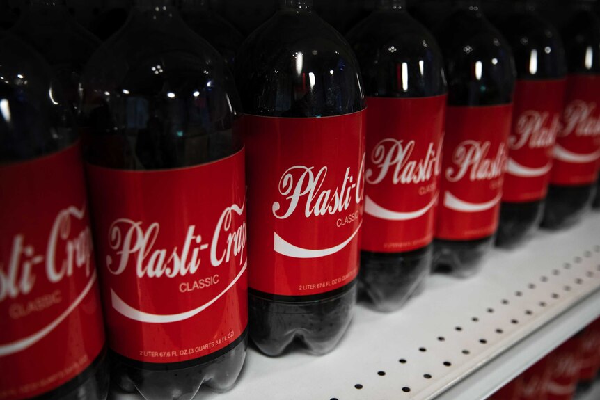 Black plastic bottles wrapped in Coca-Cola-esque labels 'Plasti-Crap Classic'