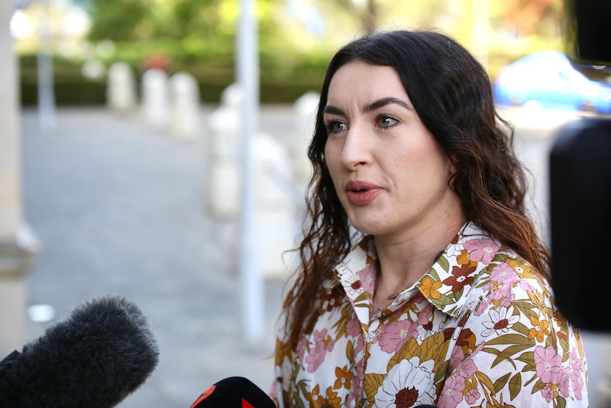 A head and shoulder shot of Magenta Marshall speaking to reporters.