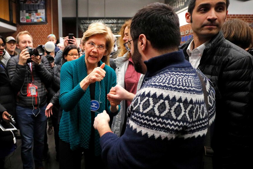 Elizabeth Warren gives a thumbs up to a supporter during campaigning in Iowa
