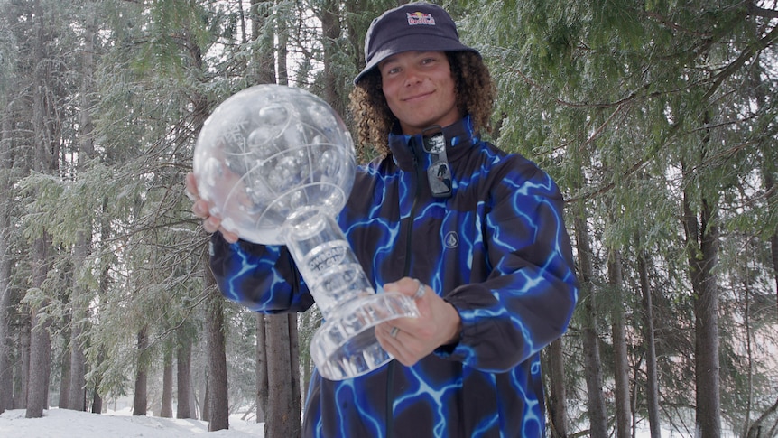 Valentino Guseli holds the World Cup crystal globe in Silvaplana, Switzerland.