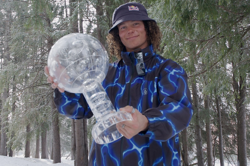 Valentino Guseli holds the World Cup crystal globe in Silvaplana, Switzerland.