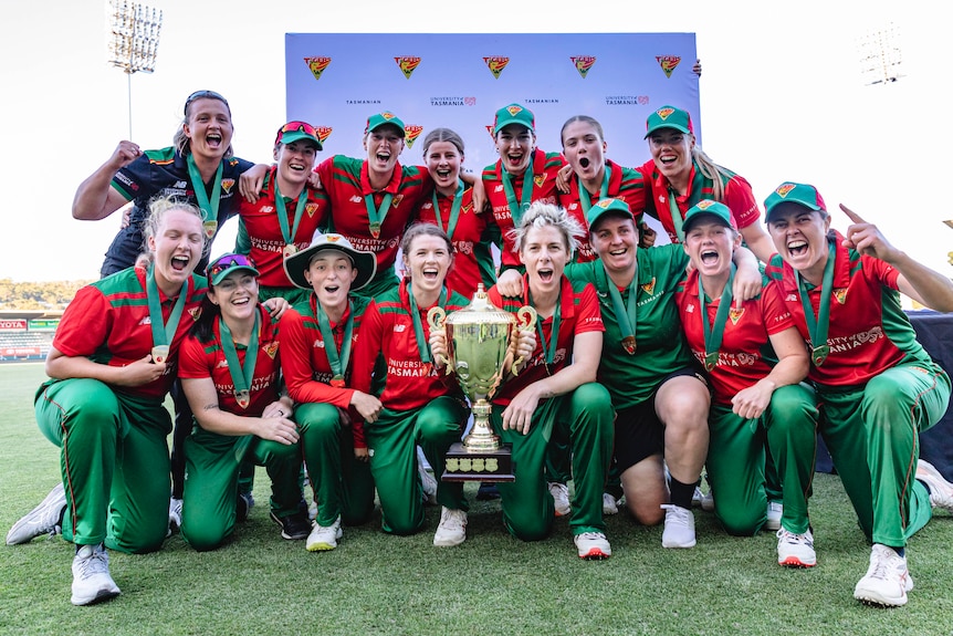 The Tasmanian team pose for a photo with the WNCL trophy.