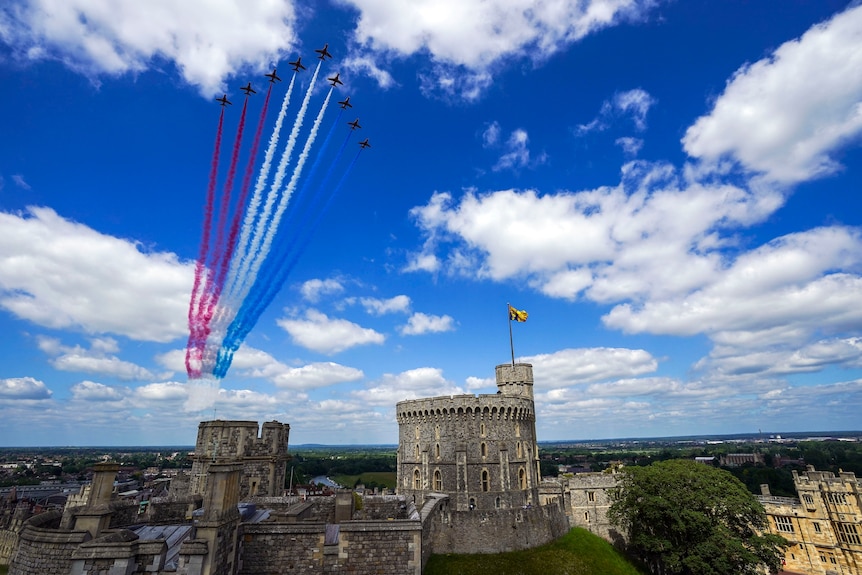 The Red Arrows fly over Windsor Castle during the military ceremony.