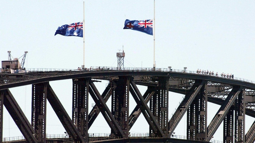Flags on Sydney Harbour Bridge fly at halfmast.