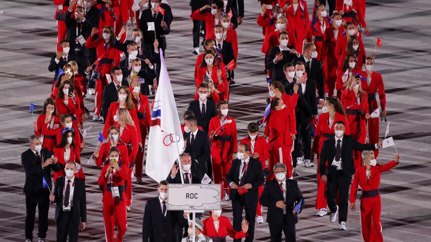 Athletes in red under an ROC banner.