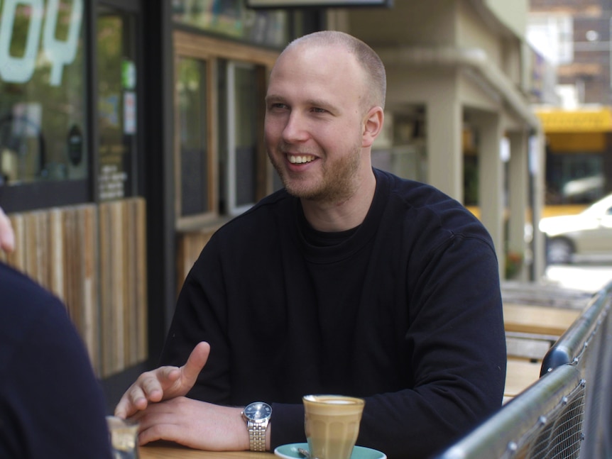 Jack Nagle at a cafe drinking coffee