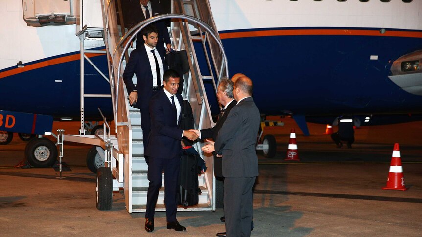 The Socceroos, led by Tim Cahill, get off the plane in Brazil