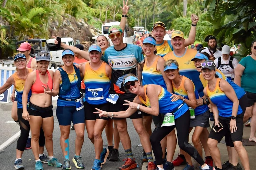 A group of runners stop for a photograph.