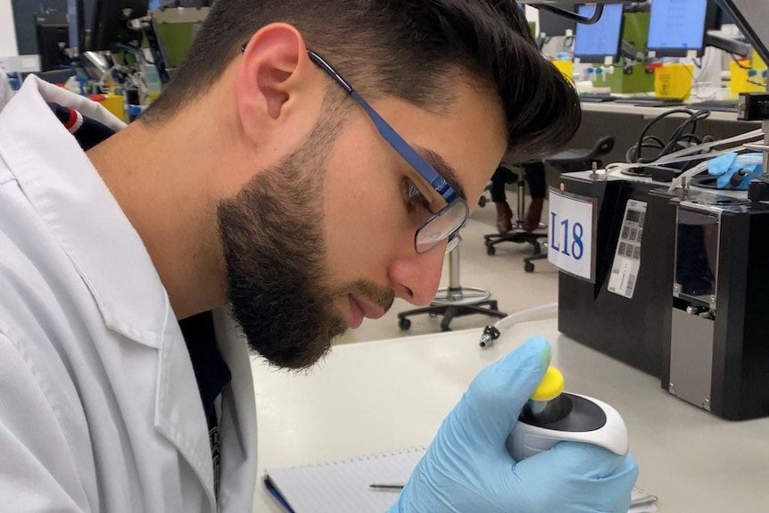 A man with a beard working in lab.