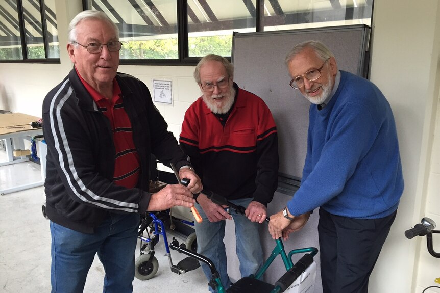 Three TADACT volunteers with disability support equipment.