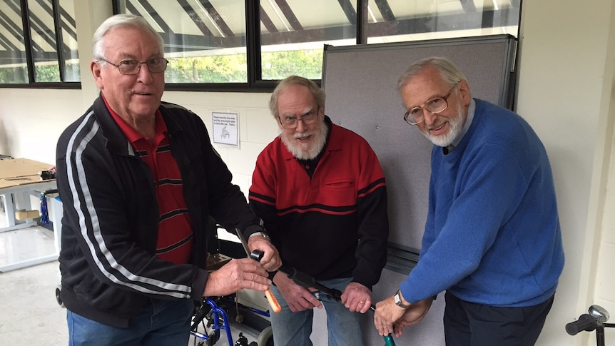 Three TADACT volunteers with disability support equipment. May 2015
