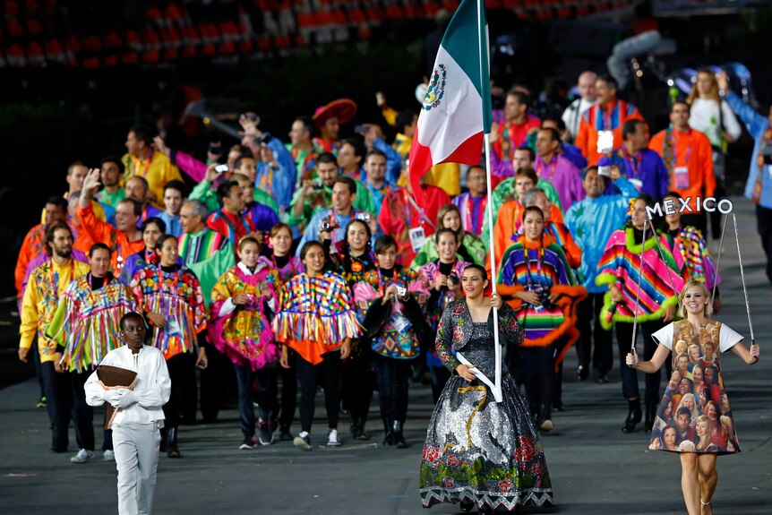 A very colourful Mexico team, being led by flagbearer Maria del Rosario Espinoza, enters the Olympic Stadium.