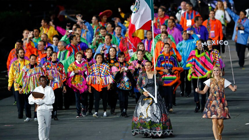 A very colourful Mexico team, being led by flagbearer Maria del Rosario Espinoza, enters the Olympic Stadium.