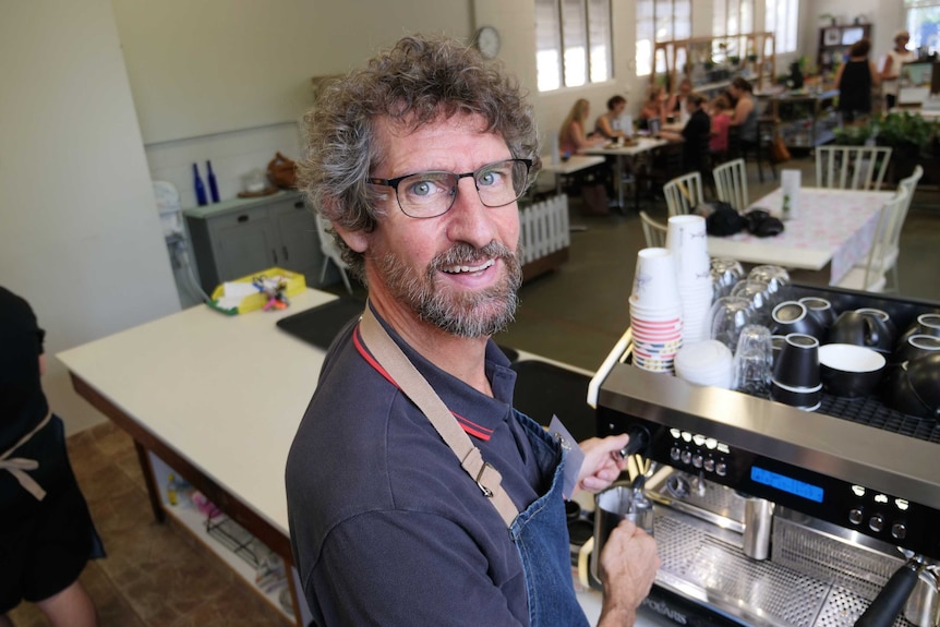 Henbury School special education support officer Rod McKay making coffee at the Henbury on Aralia cafe in Nightcliff