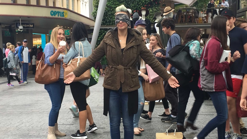 Erica Della Mura blindfolded herself and gave our hugs to strangers