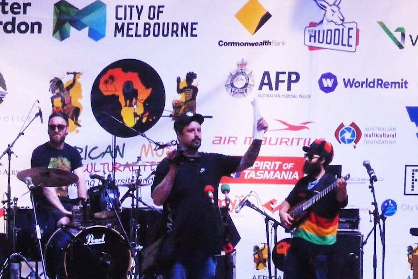 Neil Erikson stands at the microphone on the stage of the cultural event at Federation Square.