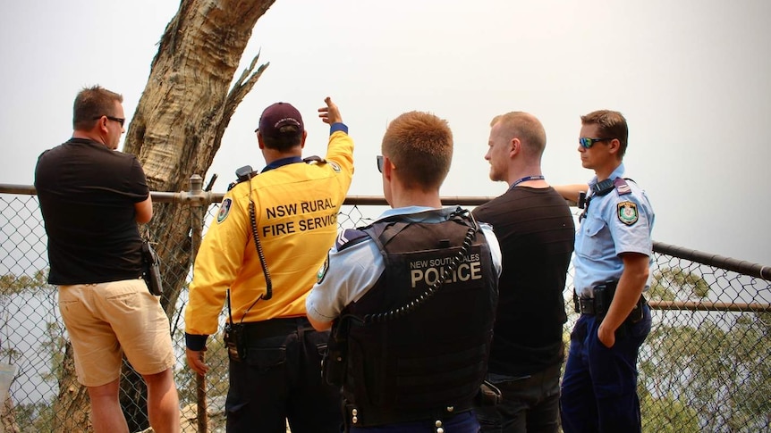 firefighters and police at a lookout point