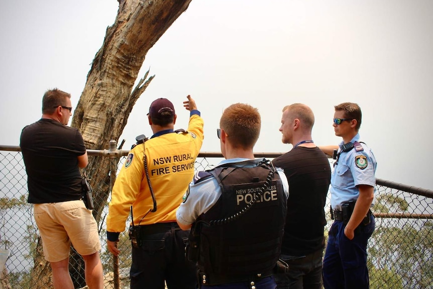 firefighters and police at a lookout point