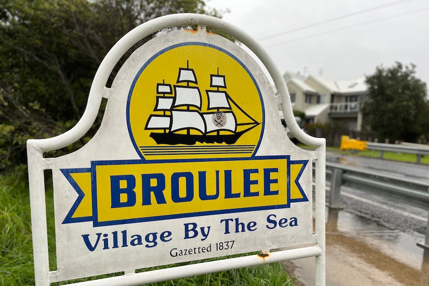 A sign by a roadside that reads "Broulee".