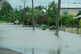 Men wade through Hinkler Avenue in Bundaberg