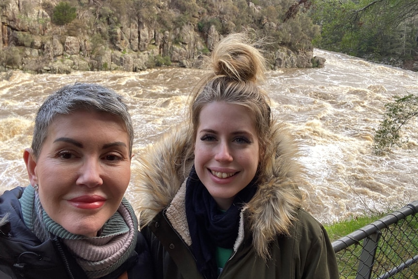 Deb Rushton with her daughter Amy at a flooded waterway.