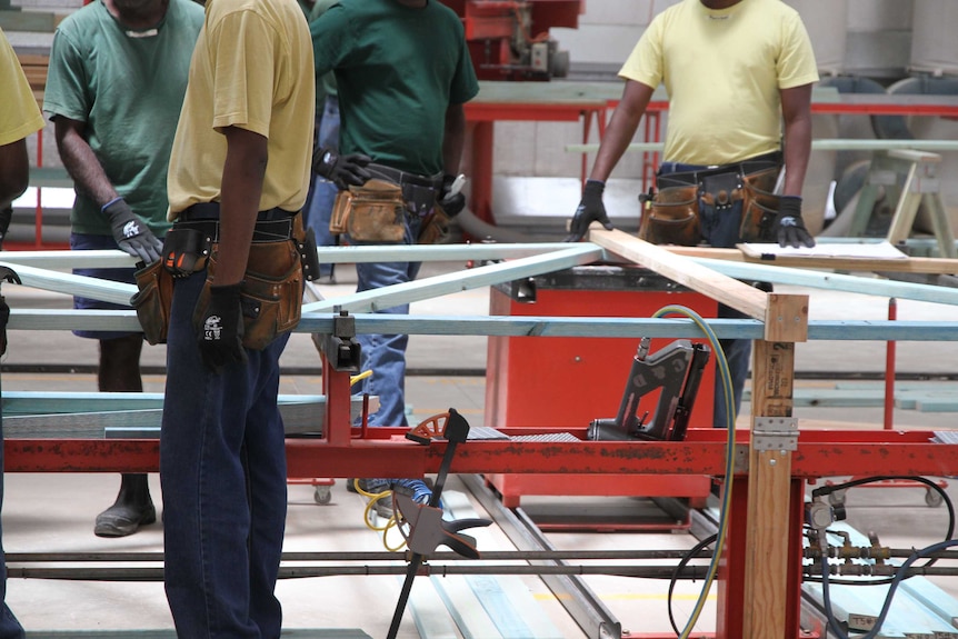 Prisoner welding steel for portable cattle yards.