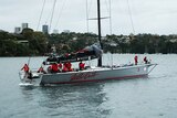 Wild Oats XI returns with its mainsail folded up.
