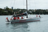 Wild Oats XI returns with its mainsail folded up.