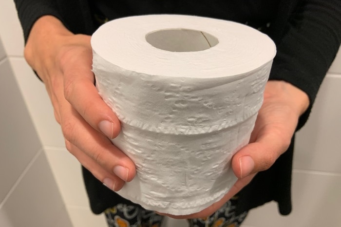 a roll of toilet paper being held close to the camera