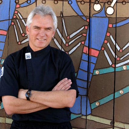 Consulting chef Andrew Fielke in front of a mural.