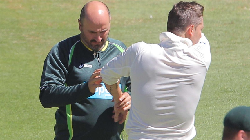 Australian captain Michael Clarke receives attention from the physio on day one at Cape Town