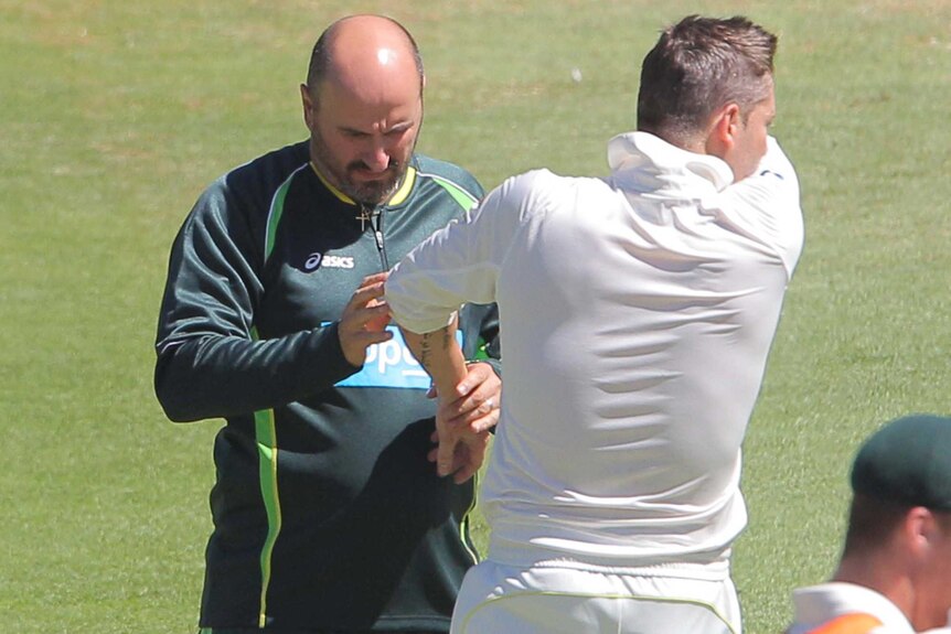 Australian captain Michael Clarke receives attention from the physio on day one at Cape Town