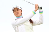 Minjee Lee holds the pose after striking an iron shot