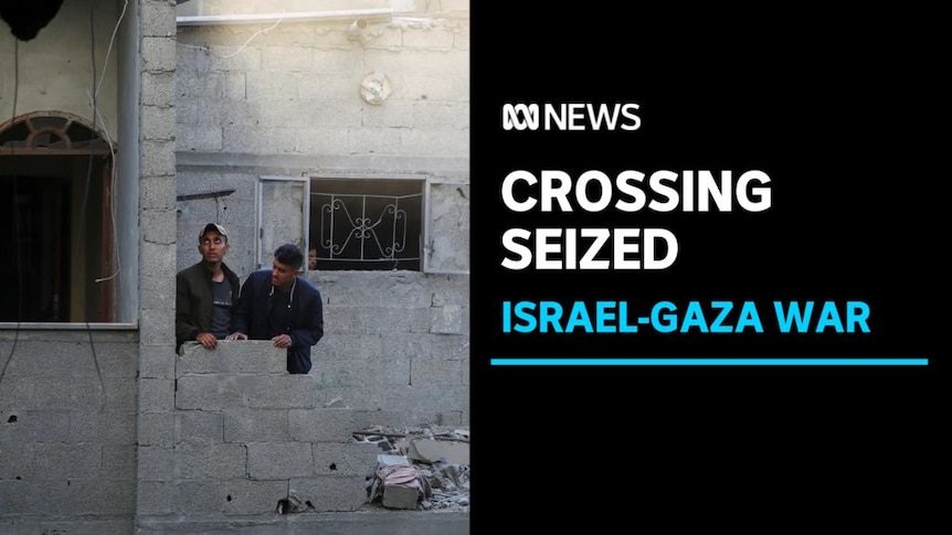 Crossing Seized, Israel-Gaza War: Two men stand at the remains of a low wall that has been all-but destroyed.