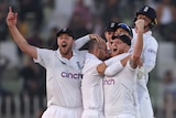 Ollie Robinson, Jack Leach and Ben Stokes embrace after defeating Pakistan in Rawalpindi