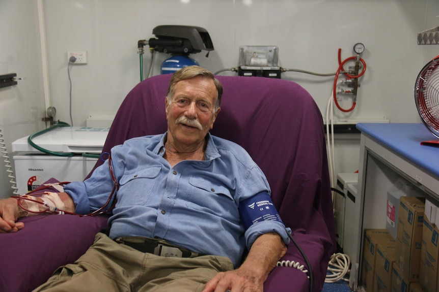 A man with a moustache sits in a dialysis chair