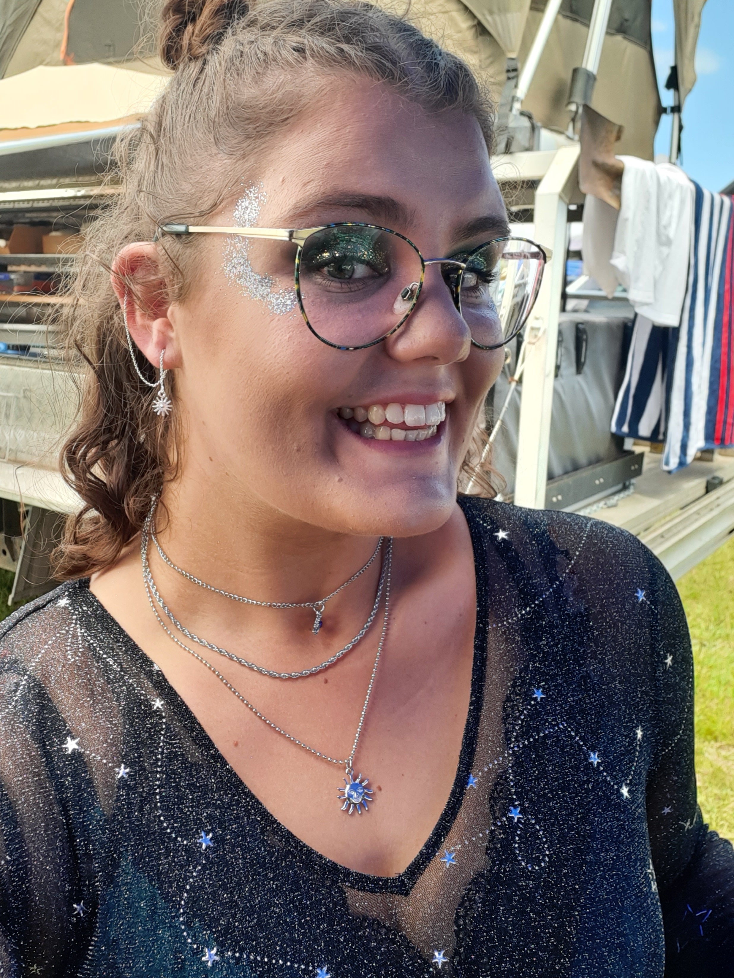 Anna-Rose wearing glasses and sparkly makeup.