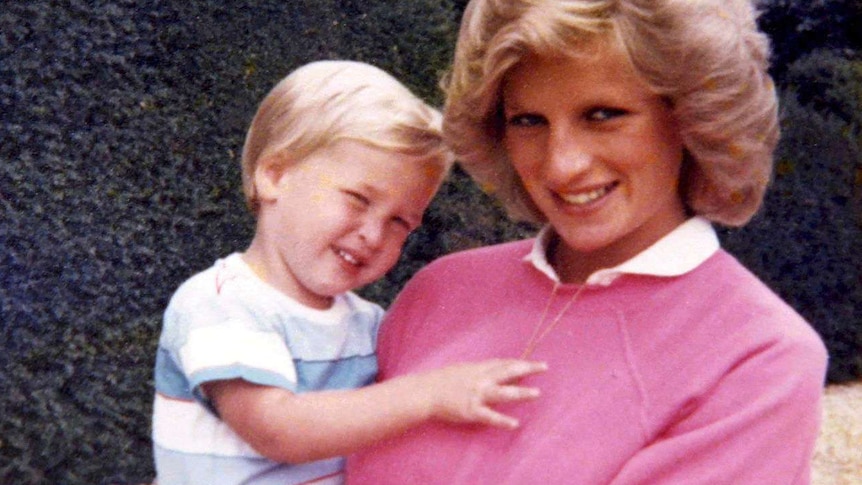 Princess Diana holds Prince William whilst pregnant with Prince Harry.