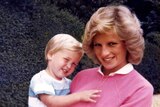 Princess Diana holds Prince William whilst pregnant with Prince Harry.