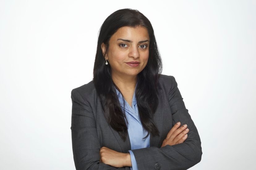 Image of woman in business suit on white background, south-asian appearance in blazer and blue shirt.