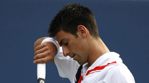 Novak Djokovic wipes his brow during the US Open men's final against Roger Federer
