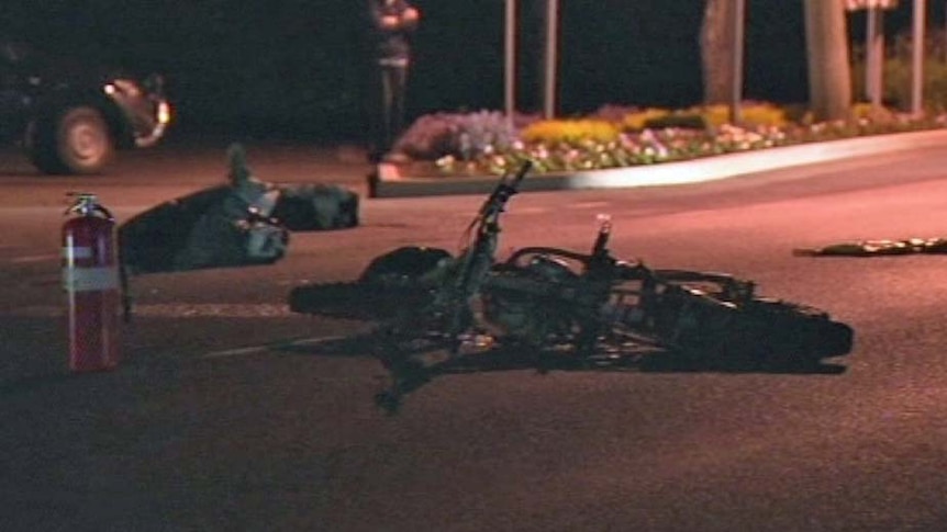 A motorbike lies on the road in Perth Tasmania after a double fatality.