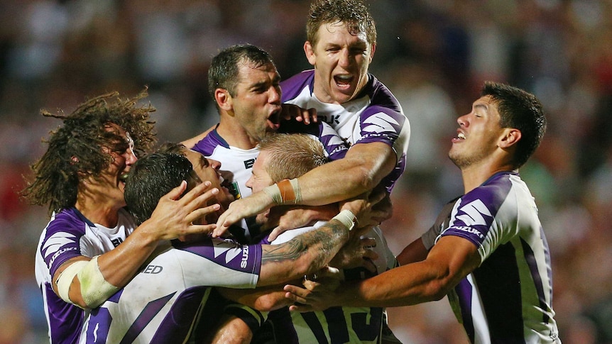 Storm captain Cameron Smith celebrates with team-mates during the round one match against Manly.