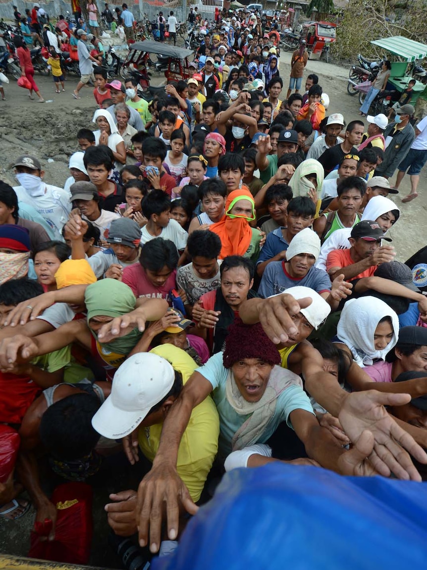 People jostle for food relief after killer storm