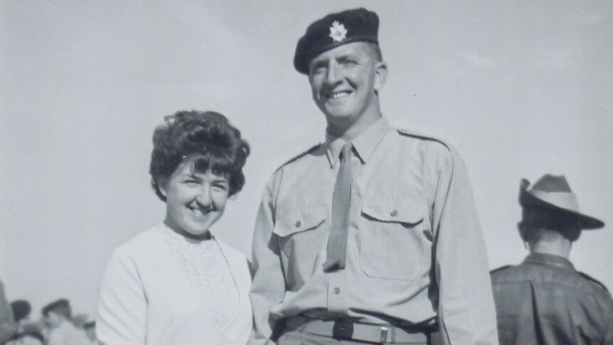 Black and white photo of Lindsay Wright in uniform with his wife.